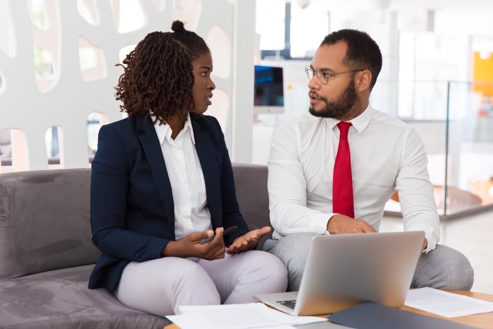 two balck professionals talking about job offers