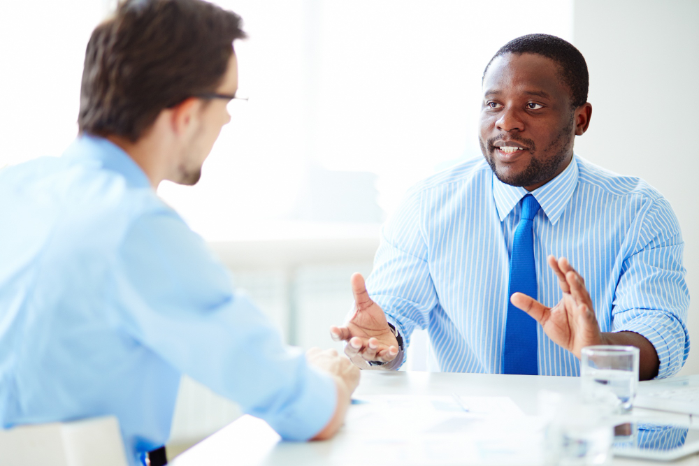 HR analyst co workers talking in the office
