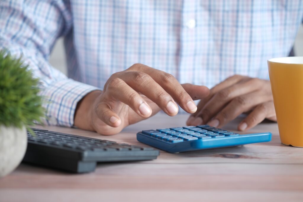 A man calculating the total finances required to get UK citizenship
