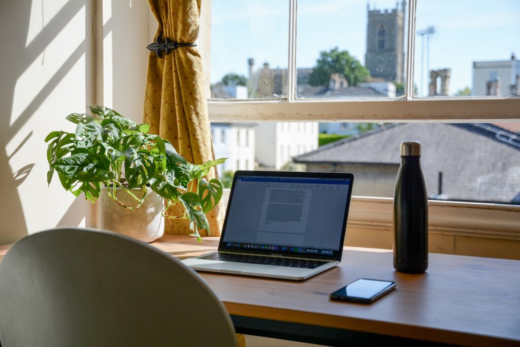 Laptop on a desk used for Remote work in the UK in an eco-friendly environment