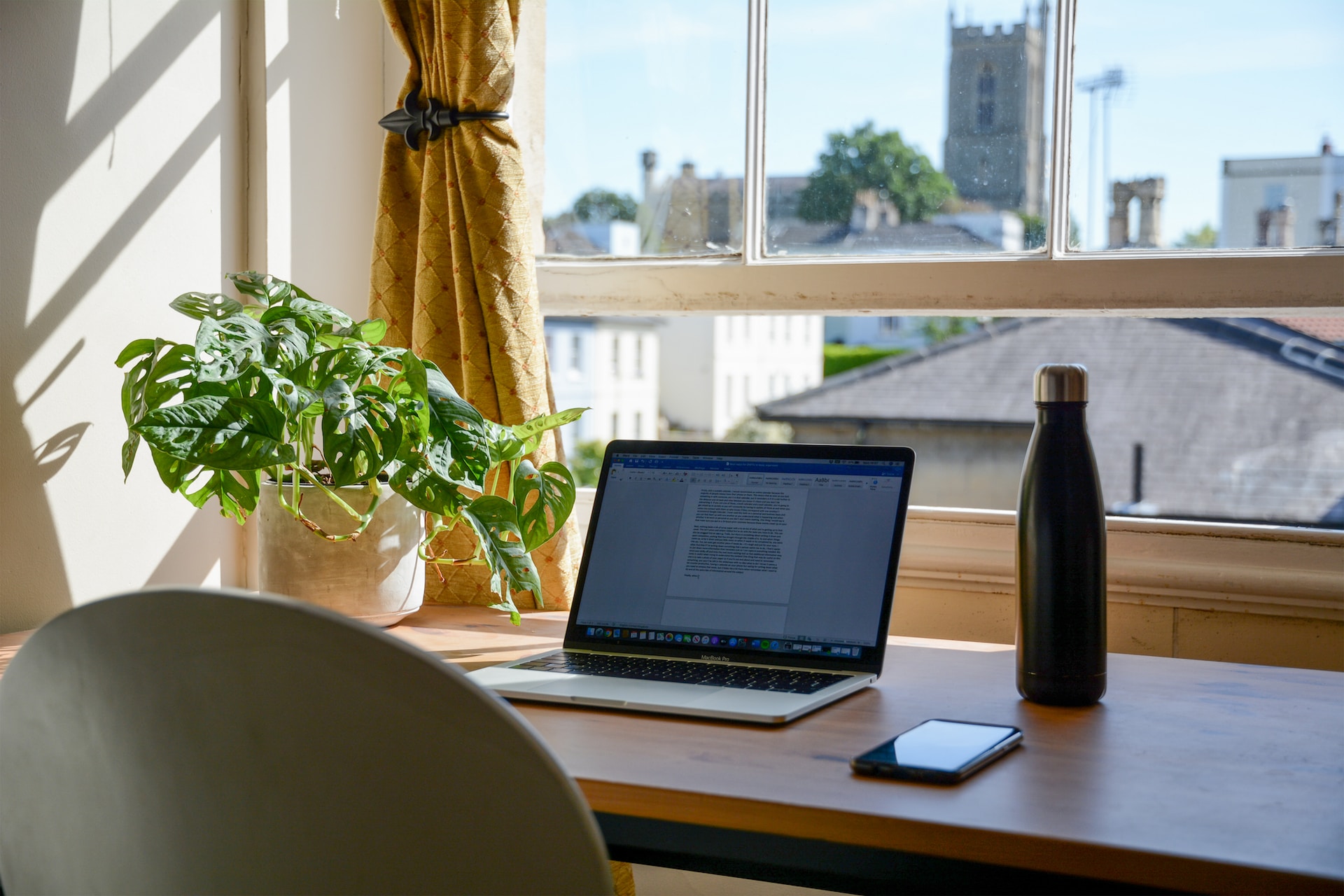 Laptop on a desk used for Remote work in the UK in an eco-friendly environment