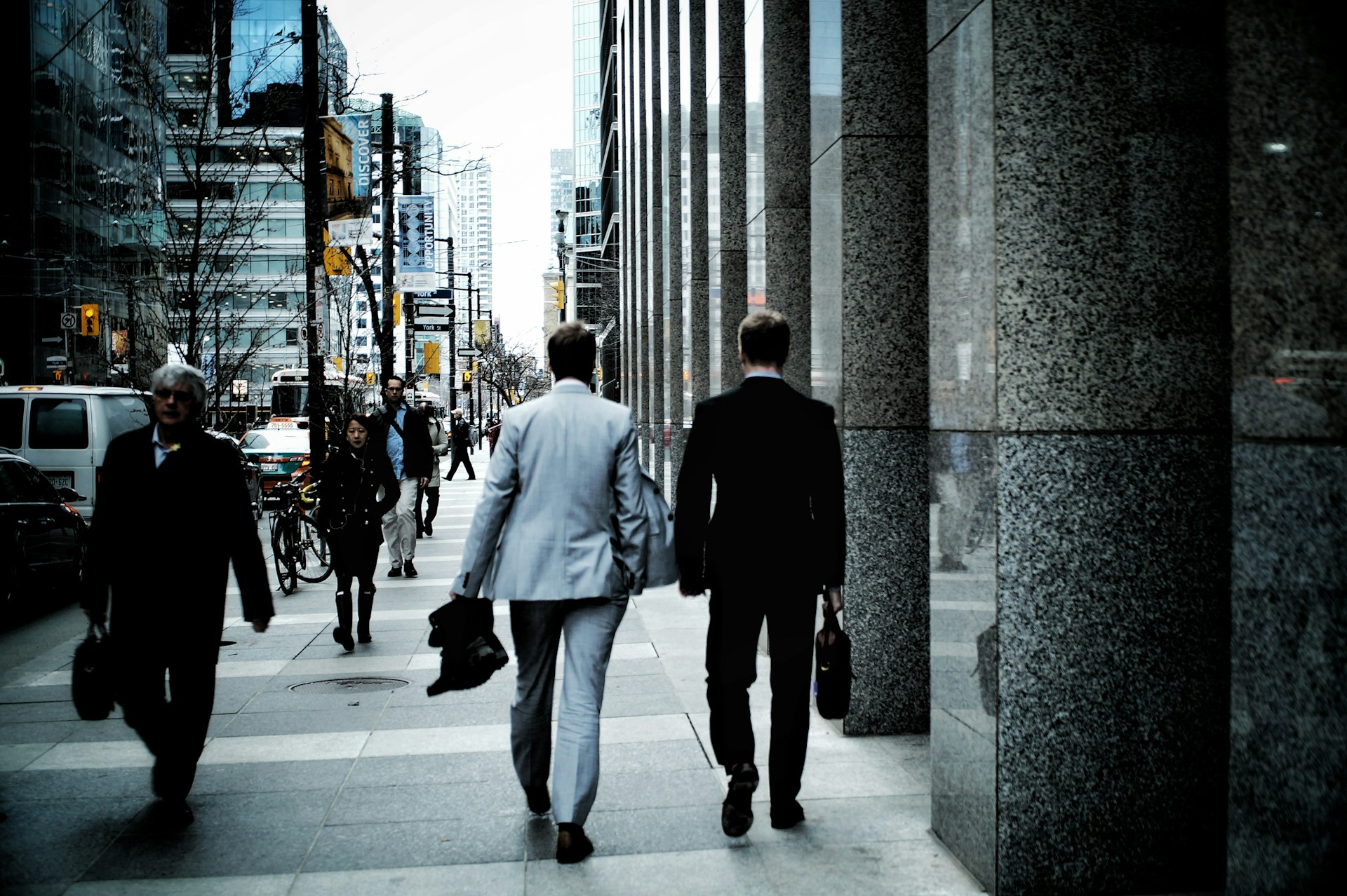Two men walking together in a Canadian city street