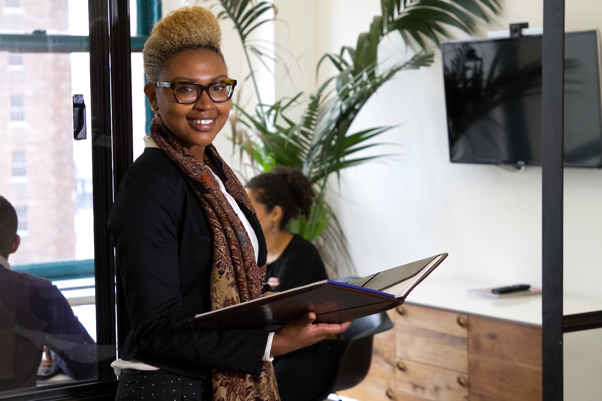 Black lady standing outside an office after discussing the highest sort-after jobs in the UK in 2024